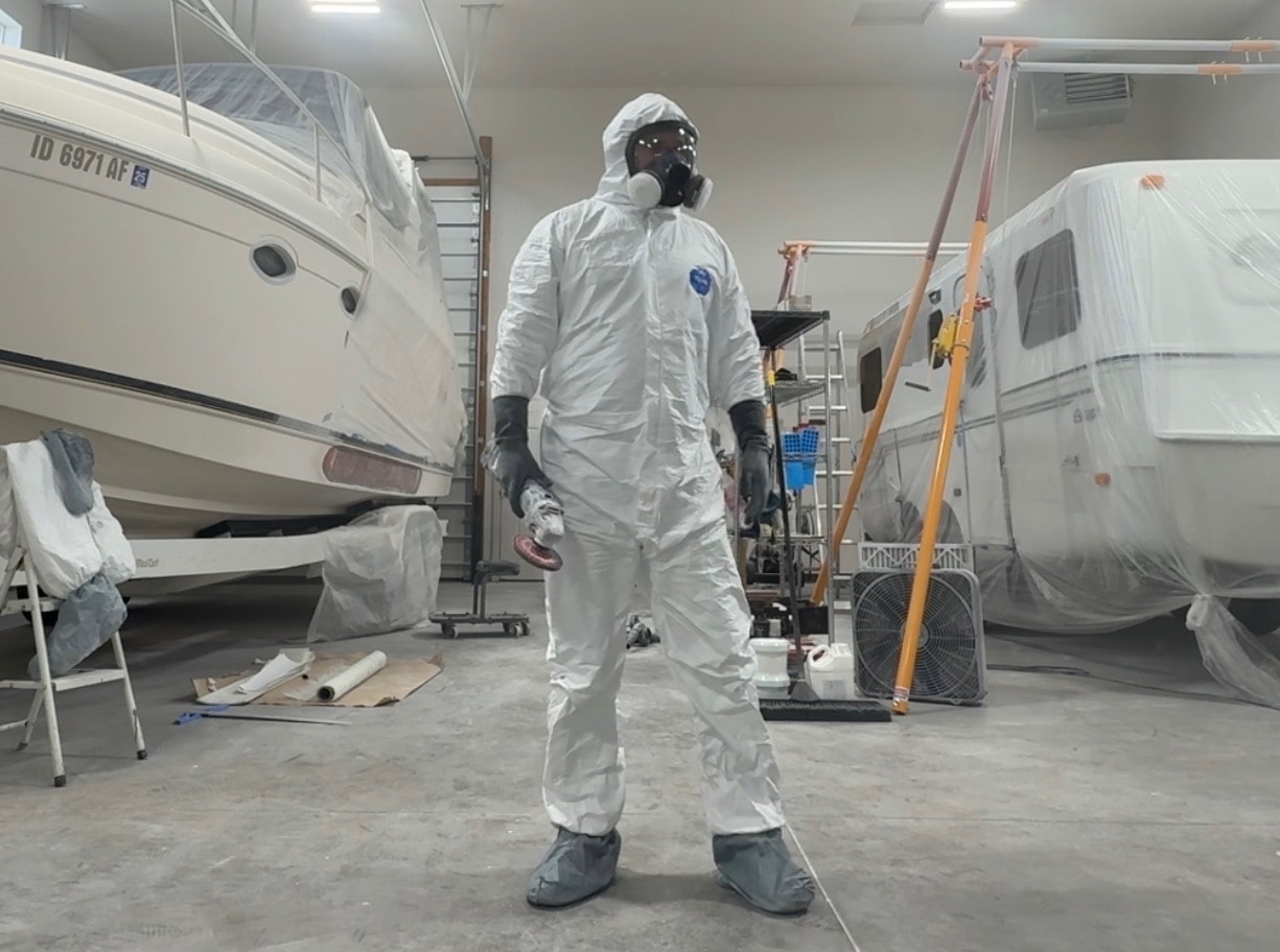 FiberCraft technician in full protective gear inside the shop